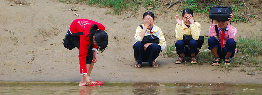 school girls in uniforms along bank of the Perfume River near Hue
