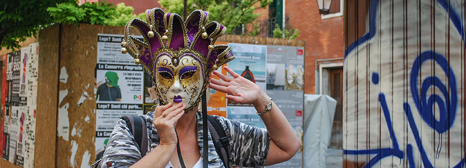 wearing a masquerade mask in Venice