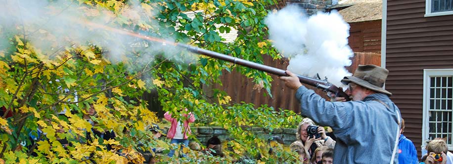 Firing an old flintlock rifle demonstration at Old Sturbridge Village Sturbridge, Massachusetts